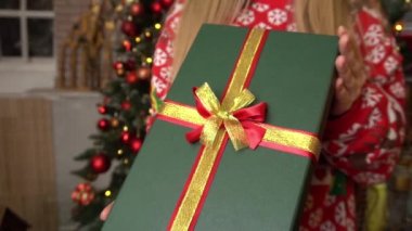 Slow Motion pozitif kız Noel Baba şapkası giyer Büyük hediye kutusunu tutar Noel 'de