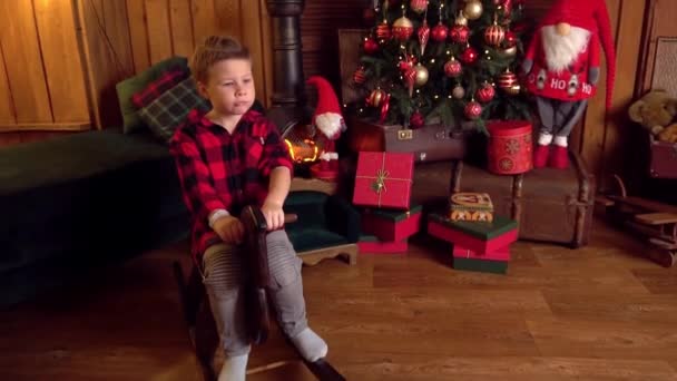 Slow Motion Happy Boy Riding Wooden Rocking Horse Front Christmas — Vídeos de Stock