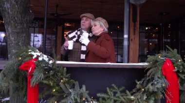 Happy senior couple sitting at coffee shop and talking.