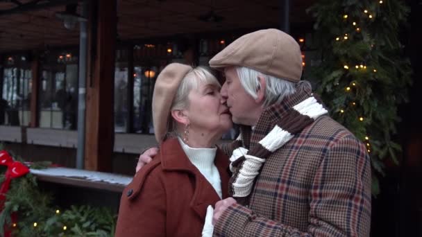 Slow Motion Happy Senior Couple Kissing Christmas Market — Stockvideo