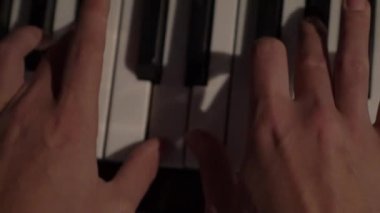 Slow Motion Piano keyboard with human hands close up.