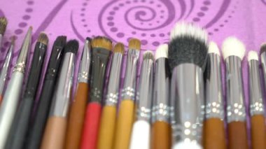 Slow Motion Makeup artist's brushes are on the table.