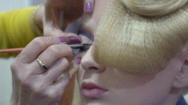 Wedding makeup artist making a make up for bride. Beautiful sexy model girl 