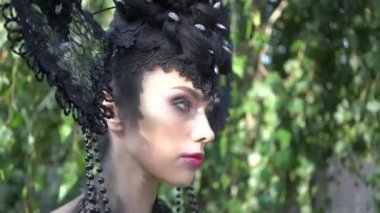 4K Woman with perfect hairstyle and creative hair-dress in nature