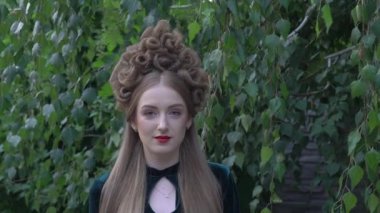 Slow Motion Woman with perfect hairstyle and creative hair-dress in nature