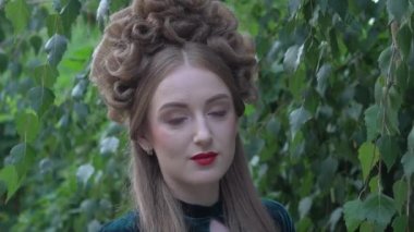 Magnificent princess in vintage dress in the garden