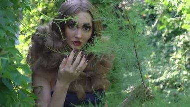 Slow Motion Fashion portrait of young woman in garden. Beauty summertime
