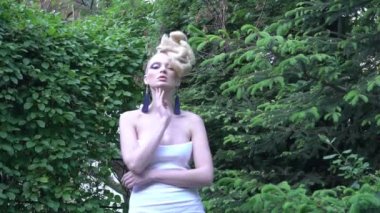 Slow Motion woman with blonde hair in white dress