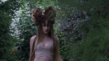 Slow Motion elf queen walks in green garden