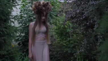 Portrait of a young brunette woman in the form of an elf, druid or fairy. 