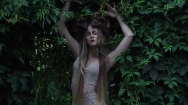 Slow Motion a girl in a light dress in an garden