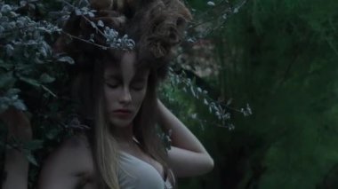 Slow Motion beautiful mystic elf in dress in woods