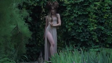 Slow Motion elegant mystic elf in dress in woods