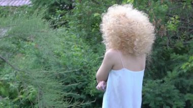 Slow Motion woman looking at camera with smile outdoor