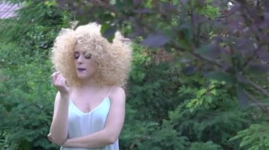 Portrait of a young beautiful woman rounded by plants