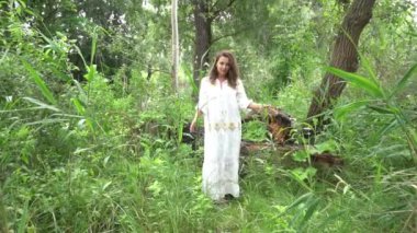 Slow Motion Young happy woman in green field
