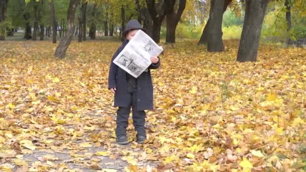 Slow Motion Beautiful Young Boy Black Suit Reading Newspaper — Stockvideo