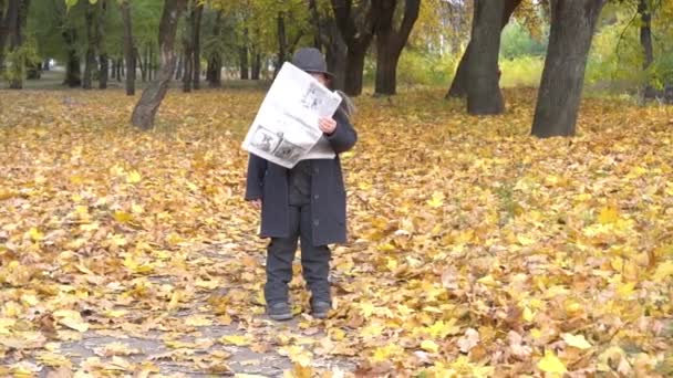 Young Boy Black Suit Reading Newspaper Autumn Park — Stok video