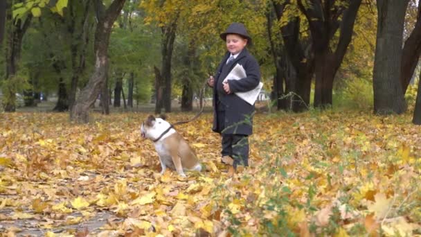 Slow Motion Boy Newspaper Dog Bulldog Autumn Park — Stockvideo