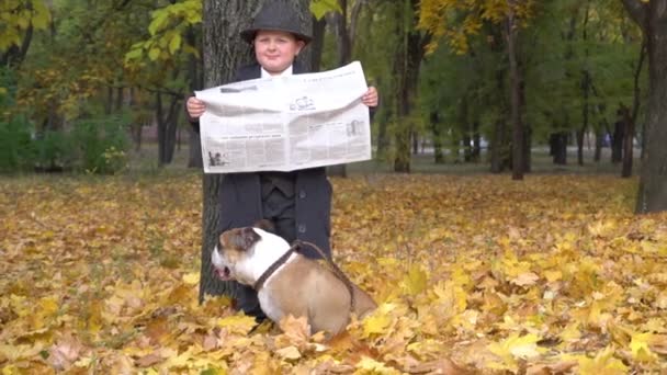 Slow Motion Child Businessman Reads Newspaper Autumn Dog — 图库视频影像
