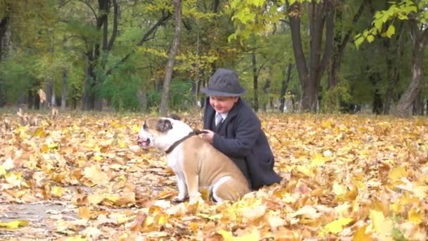 Slow Motion Little Cute Boy Playing His Dog Bulldog Autumn — Stock Video