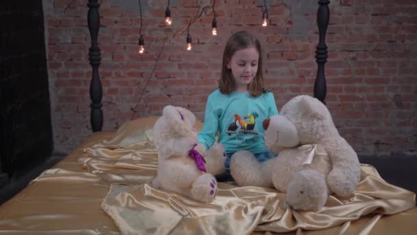 Little Girl Playing Teddy Bear While Sitting Her Bed Home — Video Stock