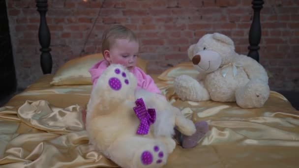 Cute Little Girl Hugging Polar Teddy Bear While Sitting Home — Stockvideo