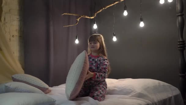 Little Girl Having Fun Throwing Pillows Home — Stockvideo