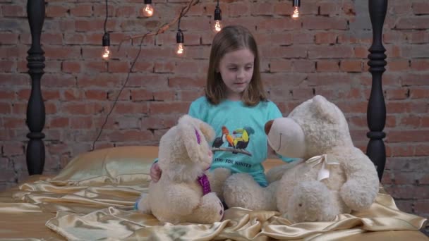 Slow Motion Beautiful Little Girl Playing Her Teddy Bear Bed — Stock Video
