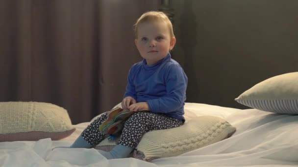 Beautiful Cute Caucasian Baby Girl Reading Looking Book Bed — Stockvideo