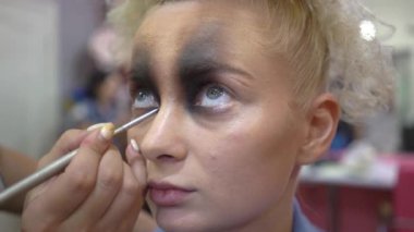 4k Beautiful young woman applying makeup beauty visage brush.