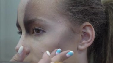 Hand of make-up master puts blush on cheeks beauty model girl