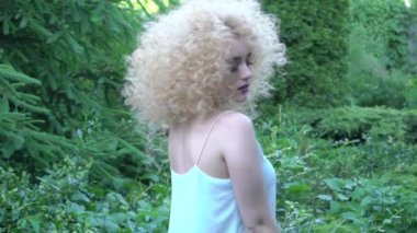Slow Motion Portrait of curly woman in the park