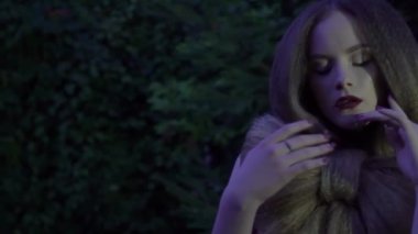 Slow Motion A sexy woman with a makeup posing outdoors