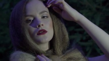 Slow Motion pretty girl in jungle wondering around and look strong