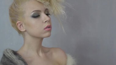 Slow Motion sexy blonde girl covered with a blanket