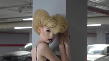 Slow Motion Young woman posing on underground car parking. 