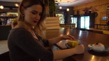 4K Portrait of a beautiful young woman relaxing at cafe