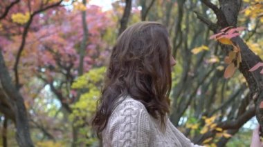 Slow Motion Woman in yellow autumn park. 