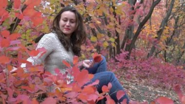 Portrait of a beautiful young woman in the autumn forest