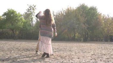 Slow Motion happy and loving couple in the setting sun on a horse farm