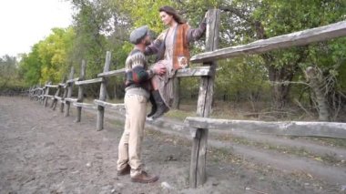 Slow Motion Couple of newlyweds on the background of a corral