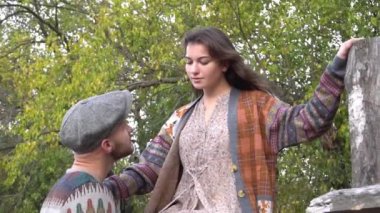 Slow Motion loving young couple inside stables looking at each other