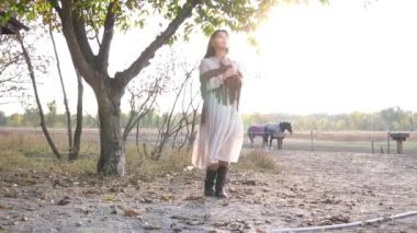 Slow Motion Young beautiful girl with a horse on the dry field