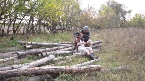 Young Couple Love Sitting Wood Log Hugging Each Other — Stockvideo