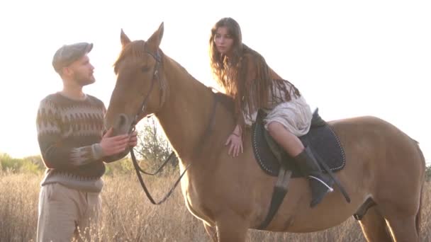 Slow Motion Young Man Helps Woman Ride Horse — Vídeos de Stock