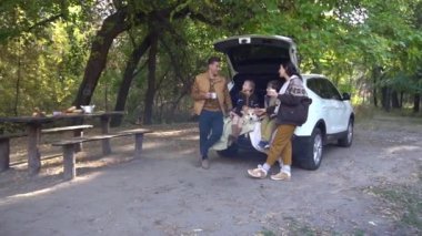 Slow Motion father mother and kids sitting back of car