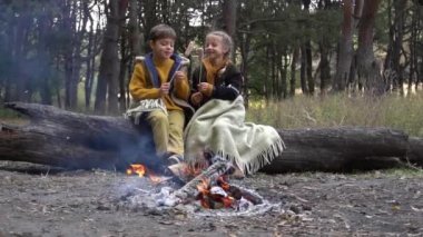 Slow Motion Two Children Roasting Hot Dogs while Camping