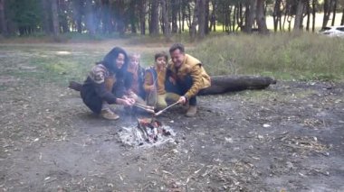 Happy family near campfire