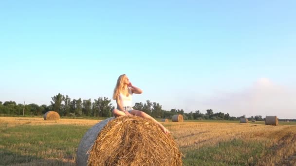 Slow Motion Girl Sitting Haystack Field — Video Stock